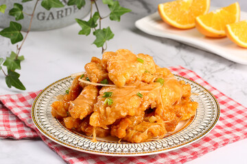 Golden Crispy Fried Cauliflower on Vintage Plate with Orange Slices - Traditional Home Cooking Style