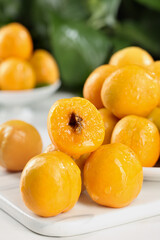 Fresh Ripe Apricots on White Plate - Organic Summer Stone Fruit Ready to Pick and Eat