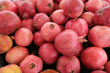 A vibrant pile of pinkish-red pomegranates