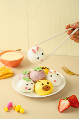 Adorable Cartoon Animal Face Steamed Buns Colorful Asian Snacks for Kids with Chopsticks and Fresh Fruit
