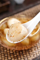 Chinese Water Chestnut Dessert in Sweet Syrup on Ceramic Spoon Traditional Asian Cuisine