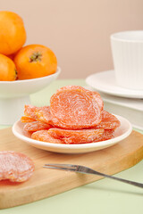 Dried Candied Loquat Fruit Preserves with Sugar Coating and Fresh Loquats on Kitchen Table