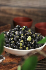Dry Roasted Black Beans with Sprouts in White Bowl on Rustic Wooden Table
