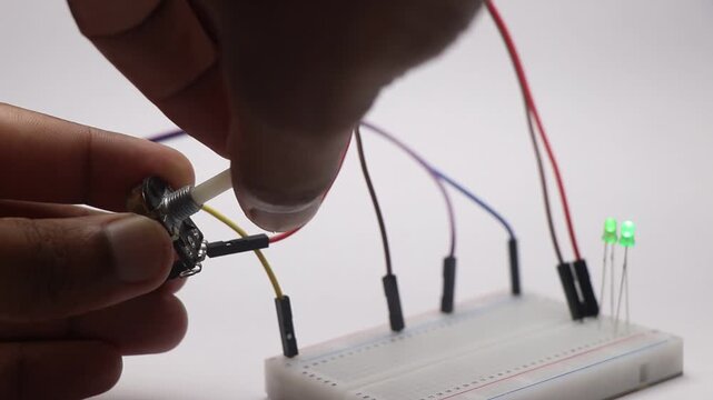 Potentiometer with variable resistance is controlling the LED light to different brightness on a breadboard