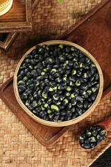 Fried Black Beans with Crispy Salt in Wooden Bowl on Bamboo Mat Asian Cooking Ingredients
