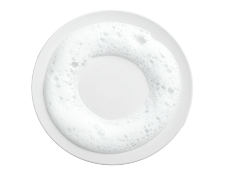 A round, white ceramic coffee cup filled with foamed milk