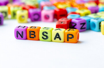 Close up of NBSAP text on multicolored cubes representing National Biodiversity Strategy and Action Plan. Conservation concept.