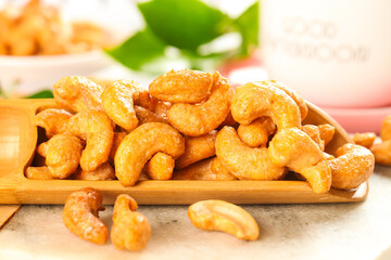Crispy Fried Salted Cashew Nuts on Wooden Plate