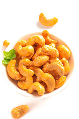 Roasted Salted Cashew Nuts in Bowl with Mint Leaf Garnish on White Background