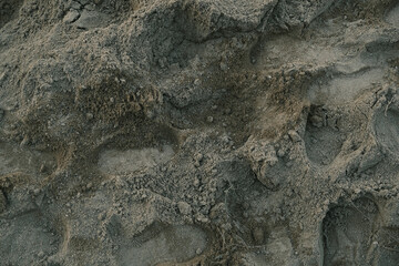 A rocky surface with a lot of texture and a few small holes