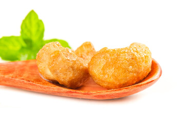 Crystallized Candied Ginger Pieces with Fresh Mint on Wooden Spoon