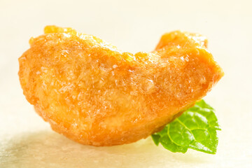 Crispy Golden Fried Food with Fresh Mint Leaf Garnish - Culinary Photography