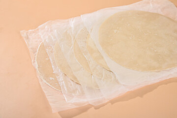 Raw buckwheat pie crust dough with coarse grain texture wrapped in plastic for baking