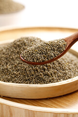 Organic Millet Seeds in Wooden Spoon - Healthy Whole Grain Cereal for Nutritious Cooking