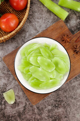 Fresh Sliced Green Vegetables in Bowl with Tomatoes and Celery on Rustic Kitchen Counter