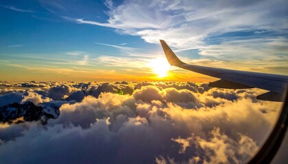 Airplane wing view of a sunrise above clouds