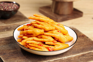 Spicy Pickled Chicken Feet Claws with Chili Oil Asian Appetizer on Wooden Table