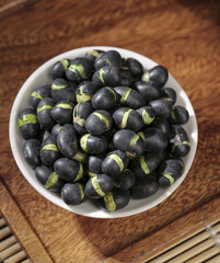 Fresh Black Lima Beans in White Bowl on Wooden Background