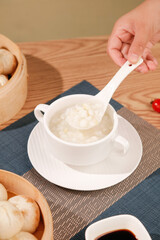 Fresh corn soup with xiaolongbao dumplings traditional Asian meal setup