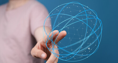 A person's hand pointing at a digital globe, representing technology, data, and connection. This...