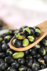 Crispy Fried Black Beans with Green Cores on Wooden Spoon - Healthy Legume Snack