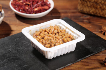 Japanese Natto Fermented Soybeans in White Container on Slate Board Traditional Healthy Food
