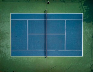 Tennis Court from Above: High-angle view of a meticulously maintained tennis court, emphasizing the geometric precision of the lines.