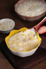 Fresh White Corn Soup in Yellow Bowl with Wooden Spoon - Healthy Comfort Food Recipe