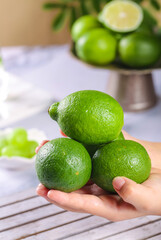 Fresh Green Limes in Hands - Healthy Citrus Fruit for Cooking and Drinks