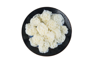 Fresh lotus root slices on black plate - Asian vegetarian ingredient with natural honeycomb texture pattern