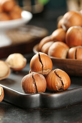 Cracked Hazelnuts on Wooden Tray - Fresh Shelled Nuts Display with Natural Brown Shells and Kernels
