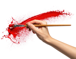 Hand holding paintbrush, red paint splatter