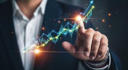 Businessman's hand interacting with a glowing financial stock market data graph display