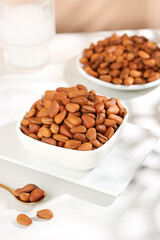 Fresh Peeled Pine Nuts in White Bowls - Natural Healthy Food Ingredients on Marble Background