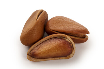 Fototapeta premium Pine Nuts with Shells and Kernels on White Background - Natural Tree Nuts Close-Up