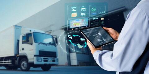 Naklejka na ściany i meble Business Logistics warehouse management system technology concept.Man hands using tablet on blurred warehouse as background
