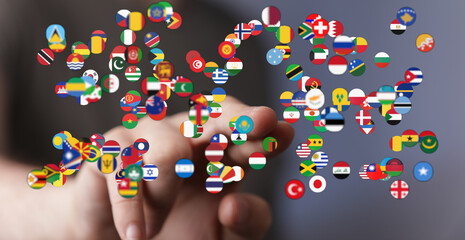 A person's hand interacts with a collection of various country flags in the form of floating...