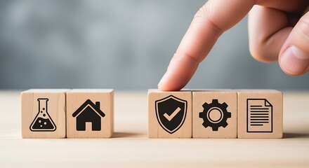 Finger presses wooden block with shield and gear icons symbolizing safety and efficiency