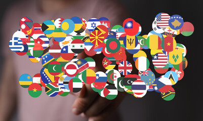 Abstract image featuring a hand surrounded by a collection of international flags representing...