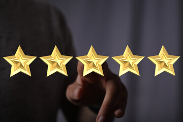 A hand pointing at five gold stars representing a perfect rating or review. Ideal for concepts of...