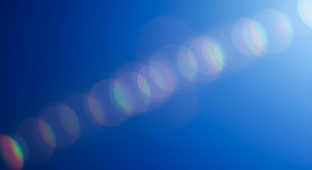 Bright abstract blue background with lens flare effect for creative designs