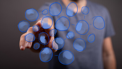 Man's hand interacts with a holographic display of a network, symbolizing business connections, data flow, innovation, and digital strategy.