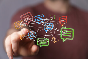 Networked digital speech bubbles symbolise communication and connection. The hand interacts with the concept of messaging and information exchan