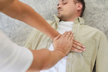 CPR emergency training, cardiopulmonary resuscitation compressions for first aid lifesaving of man. Rescuer hands practice rescue massage on unconscious patient, instructor showing hand placement