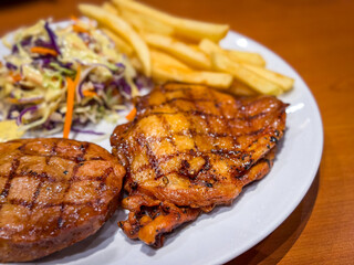 Pork steak with potato fried and salad on the table