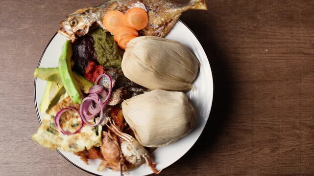 Kenkey with Fried Fish, Shrimps, Pear, Red, Black, Green Pepper Sauce and Fried Egg, Africa Ghana Traditional Dish