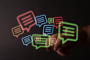 Abstract hand reaching for glowing speech bubbles, symbolizing online conversation and digital...