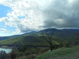 beautiful green mountain landscape with clouds upper them. autumn time