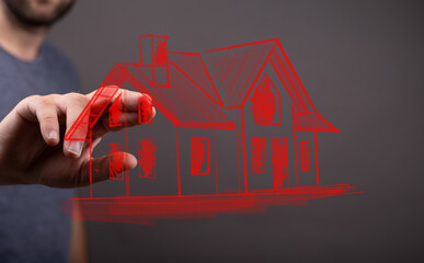 Person's hand interacting with a drawn house, illustrating home ownership, construction, or...