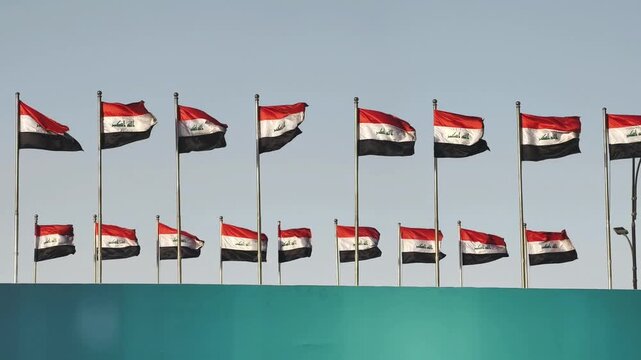 Basra, Iraq - October 11, 2025: A Row of Iraqi Flags Waving in the Wind
